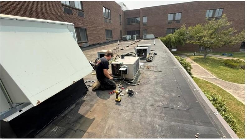 Rooftop HVAC unit replacement in progress