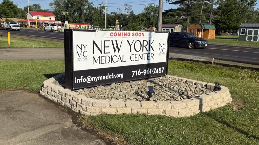 The completed roadside sign with finished stone surround and stone bed